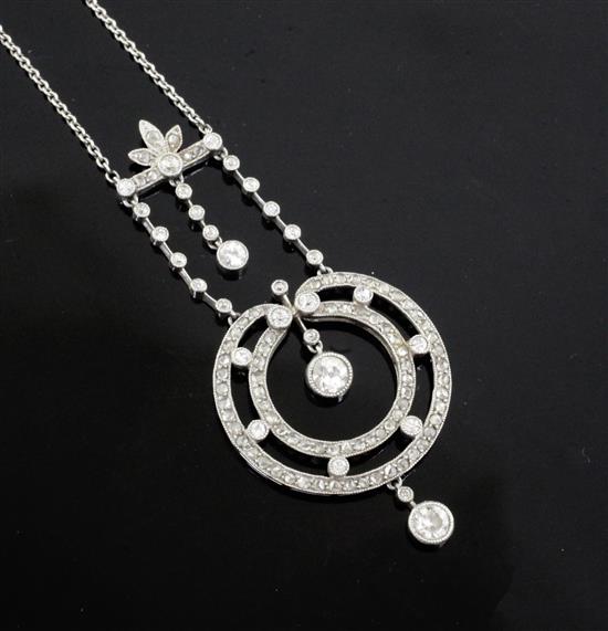 A Belle Epoque platinum? and diamond millegrain set openwork circular drop pendant necklace, approx. 47cm.